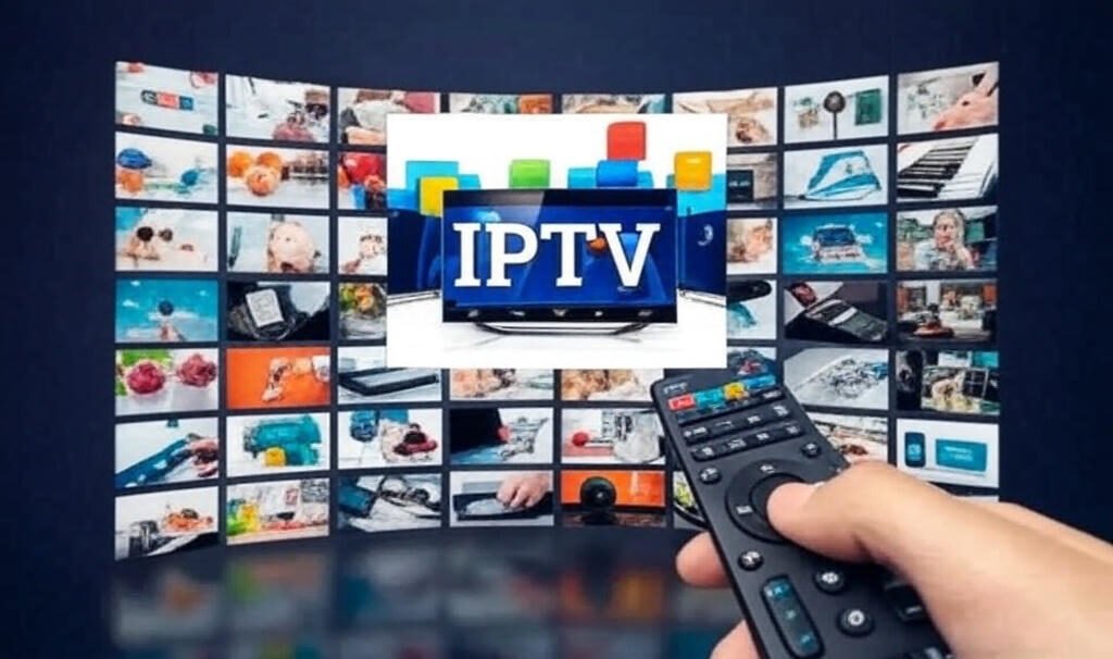 Alt text: A hand holding a remote control in front of a large screen displaying the "IPTV" logo, surrounded by a grid of colorful thumbnails showcasing various images, including fruits, household items, and people, on a dark background.